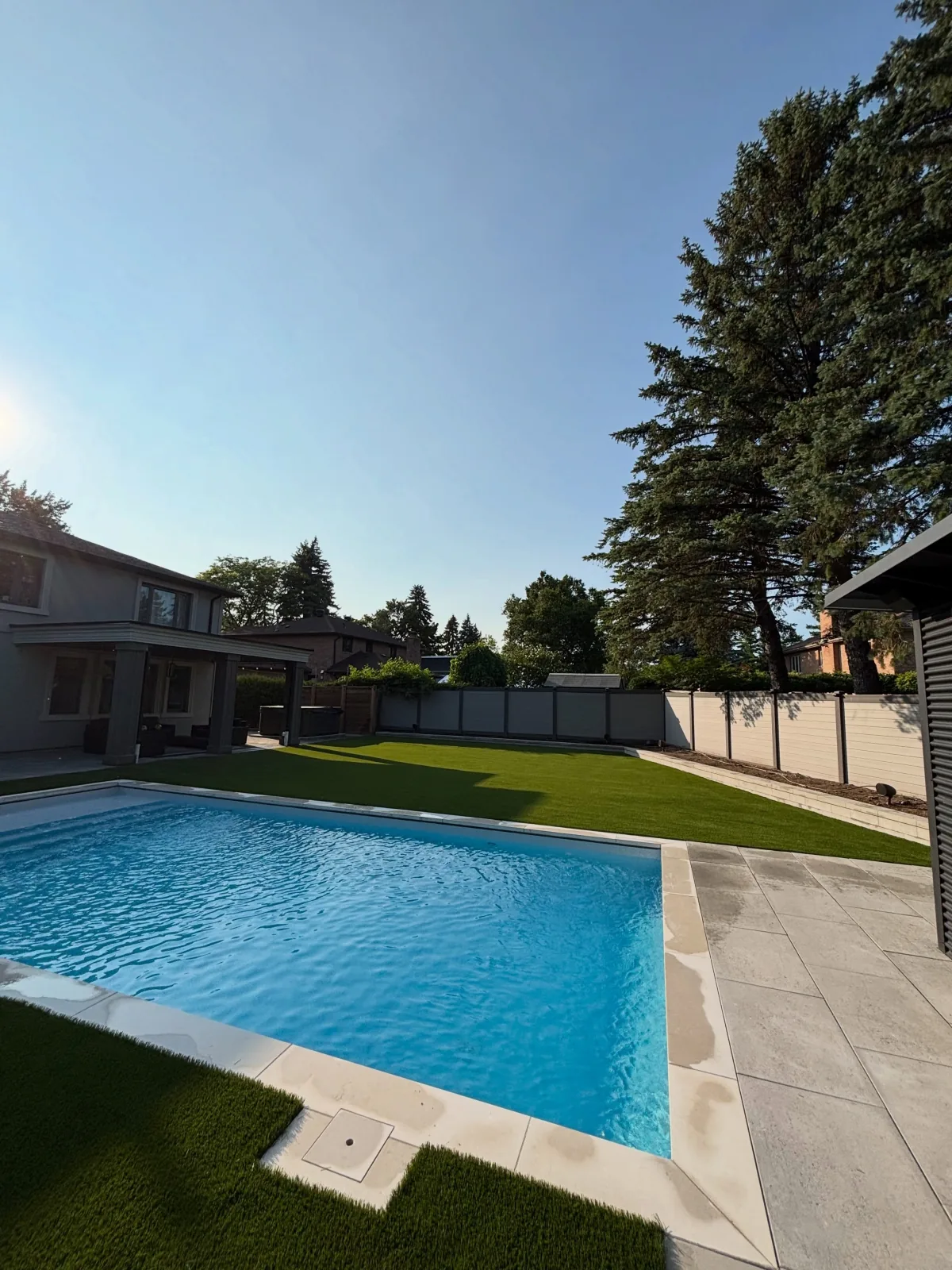 Poolside artificial grass installation in Guelph